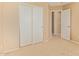 Carpeted bedroom features closet with sliding doors and view of an open doorway at 5828 E Hoover Ave, Mesa, AZ 85206