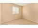 Neutral bedroom features carpet, neutral walls, and a window with horizontal blinds at 5828 E Hoover Ave, Mesa, AZ 85206