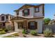 Charming two-story home featuring a stucco exterior, brown shutters, and a well-maintained landscaped front yard at 5828 E Hoover Ave, Mesa, AZ 85206