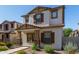 Charming two-story home featuring a stucco exterior, brown shutters, and a well-maintained landscaped front yard at 5828 E Hoover Ave, Mesa, AZ 85206