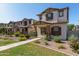Charming two-story home featuring a stucco exterior, brown shutters, and a well-maintained landscaped front yard at 5828 E Hoover Ave, Mesa, AZ 85206