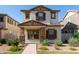 Charming two-story home featuring a stucco exterior, brown shutters, and a well-maintained landscaped front yard at 5828 E Hoover Ave, Mesa, AZ 85206