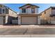 Two car garage with a double wide door, stucco exterior, and well manicured landscaping at 5828 E Hoover Ave, Mesa, AZ 85206