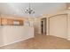 Open concept kitchen with tile flooring, bright lighting, and ample cabinet space at 5828 E Hoover Ave, Mesa, AZ 85206