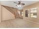 Inviting living room features a ceiling fan, carpet, and a staircase at 5828 E Hoover Ave, Mesa, AZ 85206