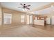 Spacious living room with a ceiling fan, carpet flooring, and natural light at 5828 E Hoover Ave, Mesa, AZ 85206