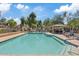 Community pool with blue lounge chairs and shaded seating area offers relaxation and fun at 5828 E Hoover Ave, Mesa, AZ 85206