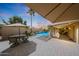 Inviting backyard boasting a covered patio, outdoor seating, and a sparkling pool at 6309 E Crocus Dr, Scottsdale, AZ 85254