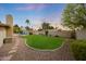 Beautiful backyard showcases a sparkling pool, lush lawn, and desert landscaping at 6309 E Crocus Dr, Scottsdale, AZ 85254