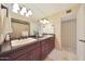 Bathroom with double sinks, dark wood cabinetry, and granite countertops at 6309 E Crocus Dr, Scottsdale, AZ 85254