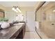 Well-lit bathroom featuring a glass shower enclosure, and granite countertops at 6309 E Crocus Dr, Scottsdale, AZ 85254