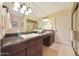 Well-lit bathroom with double sinks, granite counters, and a glass shower enclosure at 6309 E Crocus Dr, Scottsdale, AZ 85254