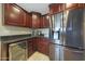 Bright kitchen showcasing stainless steel appliances, dark wood cabinets, and a wine fridge at 6309 E Crocus Dr, Scottsdale, AZ 85254