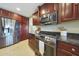 Modern kitchen equipped with stainless steel appliances, dark cabinets, and sleek granite countertops at 6309 E Crocus Dr, Scottsdale, AZ 85254