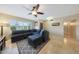 Inviting living room with tile flooring, a ceiling fan, and a large, comfortable sectional sofa at 6309 E Crocus Dr, Scottsdale, AZ 85254