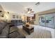 Comfortable living room with tile flooring, open to the kitchen, with sliding glass doors to the patio at 6309 E Crocus Dr, Scottsdale, AZ 85254