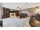 Spacious living room features tile flooring, a cozy fireplace, a ceiling fan, and comfortable leather furniture at 6309 E Crocus Dr, Scottsdale, AZ 85254