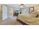 Spacious main bedroom showcasing neutral tones, a ceiling fan, and access to an ensuite bathroom at 6309 E Crocus Dr, Scottsdale, AZ 85254