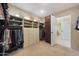 Spacious walk-in closet with ample storage shelving and hanging racks for organization at 6309 E Crocus Dr, Scottsdale, AZ 85254