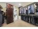 Walk-in closet with ample storage shelving and hanging racks for organization at 6309 E Crocus Dr, Scottsdale, AZ 85254