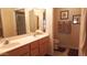 Well-lit bathroom with double sinks, a toilet, and framed artwork on the wall at 8020 E Keats Ave # 271, Mesa, AZ 85209