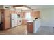 Spacious kitchen with natural wood cabinets, white appliances, and tile flooring at 8020 E Keats Ave # 271, Mesa, AZ 85209