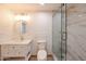 Updated bathroom features a modern vanity with gold fixtures and a glass-enclosed shower with marble tile at 8442 E Chaparral Rd, Scottsdale, AZ 85250