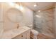 A renovated bathroom boasts a glass enclosed shower and a decorative mirror at 8442 E Chaparral Rd, Scottsdale, AZ 85250