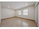 Bright bedroom with tile flooring, neutral walls, and shuttered windows that offer ample natural light at 8442 E Chaparral Rd, Scottsdale, AZ 85250