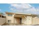 Inviting condo exterior with a covered parking area and neatly maintained front facade under a partly cloudy sky at 8442 E Chaparral Rd, Scottsdale, AZ 85250