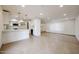 Open-concept kitchen and living area featuring recessed lights, white cabinetry, and tile floors at 8442 E Chaparral Rd, Scottsdale, AZ 85250