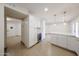 Open kitchen with white cabinetry, wine cooler, stainless appliances, quartz countertops, and pendant lighting at 8442 E Chaparral Rd, Scottsdale, AZ 85250