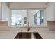 A modern kitchen sink features a window overlooking the backyard, enhancing the space with natural light at 8442 E Chaparral Rd, Scottsdale, AZ 85250