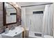 Bathroom featuring modern wood-look wall, bright lights, and walk-in shower with marble tile at 8600 E Broadway Rd # 150, Mesa, AZ 85208