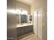 Bathroom features a double sink vanity, closet doors, and neutral wall paint at 888 E Sheffield Ave, Chandler, AZ 85225