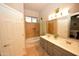 Bathroom features a double sink vanity and a tub with tile surround and a built-in niche at 888 E Sheffield Ave, Chandler, AZ 85225