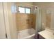 Bathroom bathtub features tile surround, a built in niche, and a shower head with window at 888 E Sheffield Ave, Chandler, AZ 85225