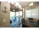 Bright dining room with modern lighting, neutral color palette, and sliding door access to the patio at 888 E Sheffield Ave, Chandler, AZ 85225