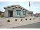 Inviting single-story home featuring a two car garage, desert landscaping, and an American flag waving in the breeze at 888 E Sheffield Ave, Chandler, AZ 85225