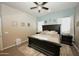 Airy main bedroom boasts a decorative rug, ceiling fan and warm accent colors at 888 E Sheffield Ave, Chandler, AZ 85225