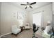 Cozy office space with chair, grey wood desk, and a ceiling fan at 888 E Sheffield Ave, Chandler, AZ 85225