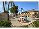 Relaxing community pool area surrounded by lush greenery and swaying palm trees on a clear, sunny day at 888 E Sheffield Ave, Chandler, AZ 85225