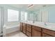 Bathroom featuring double sinks, modern lighting, shower, and separate tub at 900 W Broadway Ave # 66, Apache Junction, AZ 85120