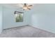 A charming bedroom features a ceiling fan, window and neutral carpet at 900 W Broadway Ave # 66, Apache Junction, AZ 85120