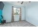 This bedroom features a ceiling fan, window with curtains, and gray carpet at 900 W Broadway Ave # 66, Apache Junction, AZ 85120