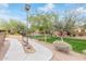 Peaceful common area with mature trees, landscaped walkways, and a dedicated dog run at 900 W Broadway Ave # 66, Apache Junction, AZ 85120