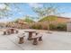 Community recreation area featuring stone picnic tables and a built-in grill, perfect for outdoor gatherings at 900 W Broadway Ave # 66, Apache Junction, AZ 85120