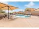 Community pool with lounge chairs and plenty of space to sit. Includes shade umbrellas at 900 W Broadway Ave # 66, Apache Junction, AZ 85120