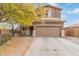 Two-story home featuring neutral stucco, a brown garage door, and a well-maintained front yard at 900 W Broadway Ave # 66, Apache Junction, AZ 85120