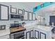 Kitchen with white cabinets featuring black trim, stainless steel appliances, and stylish countertops at 900 W Broadway Ave # 66, Apache Junction, AZ 85120